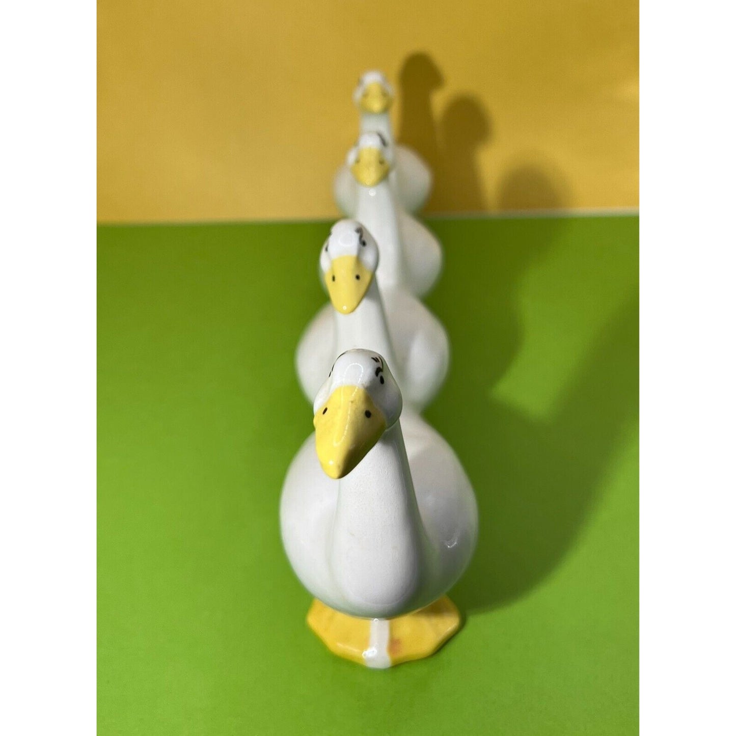 Four attached White Ducks in a Row Ceramic Descending Size Eyelashes